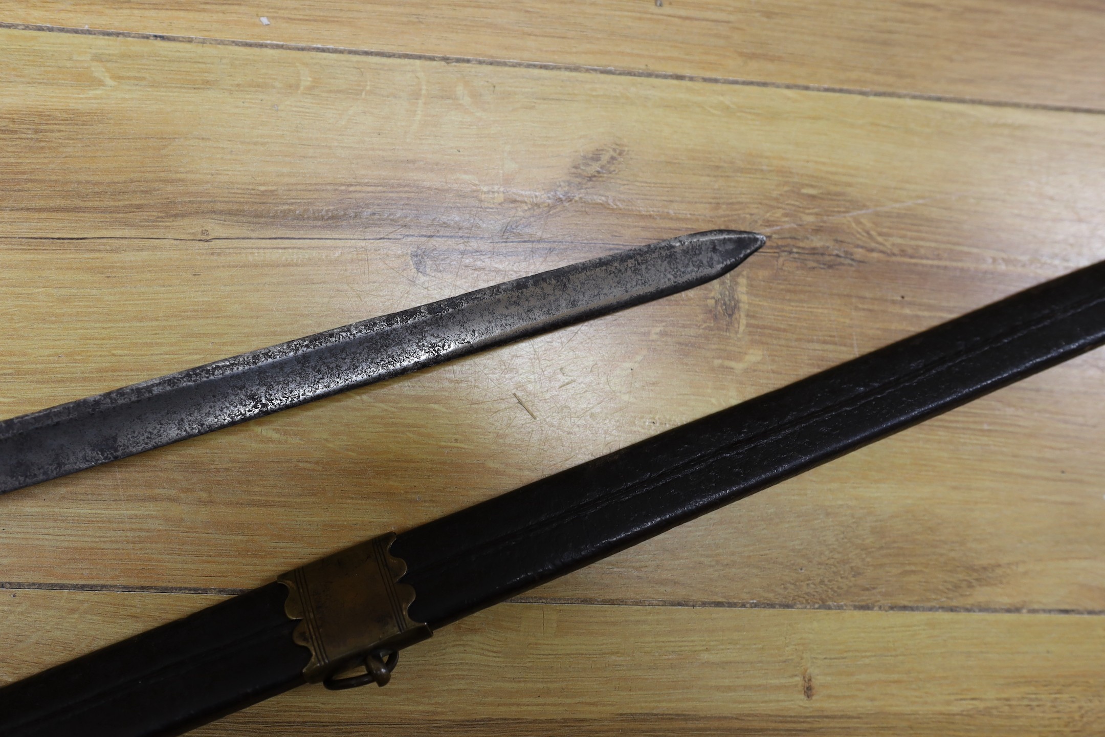 An 18th century European brass hilted sword and scabbard. 89cm long